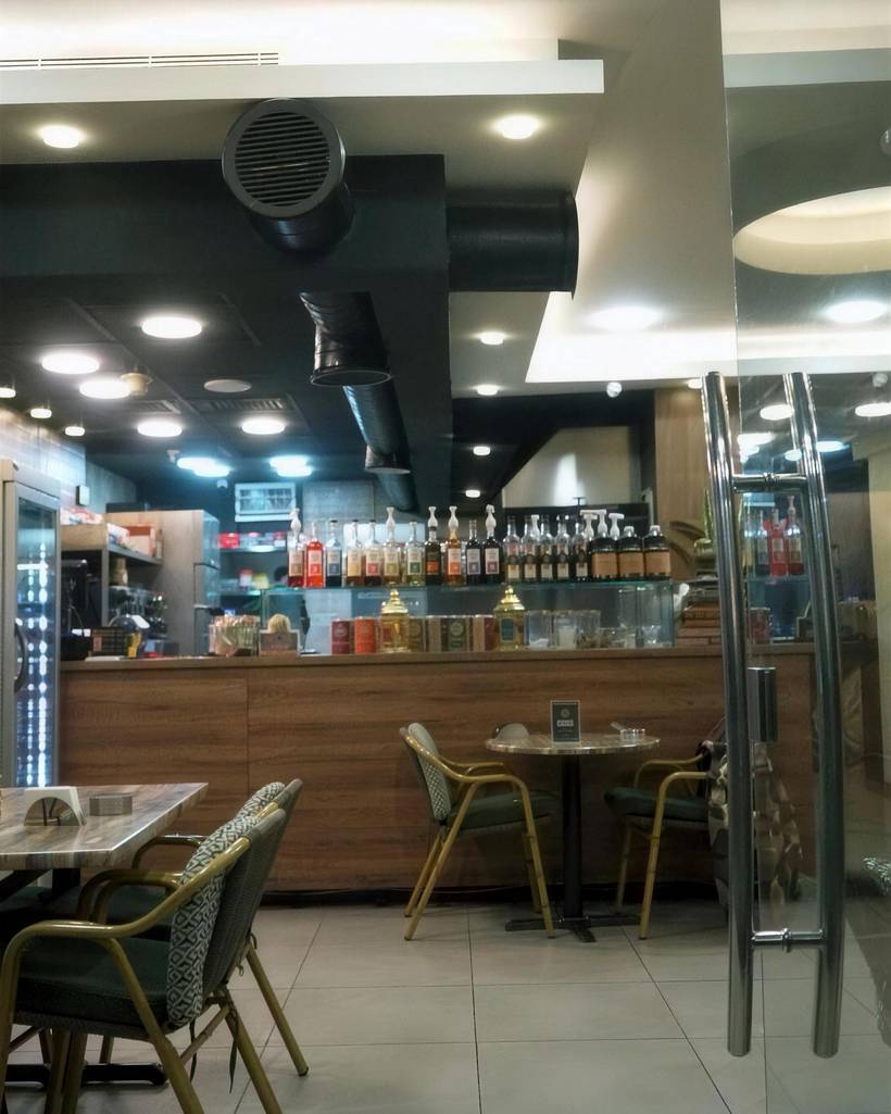 The coffee counter, with shelves of bottles and jars behind it