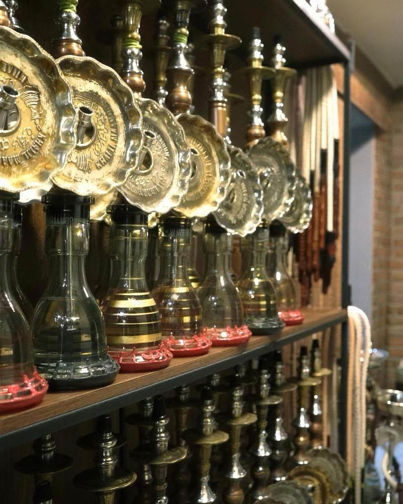 Rows of ornate nargileh pipes lined up on shelves