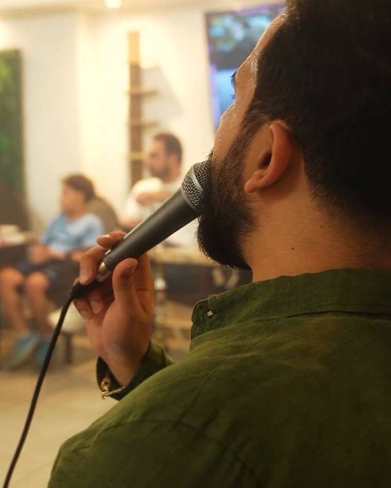 A singer with a microphone facing the room